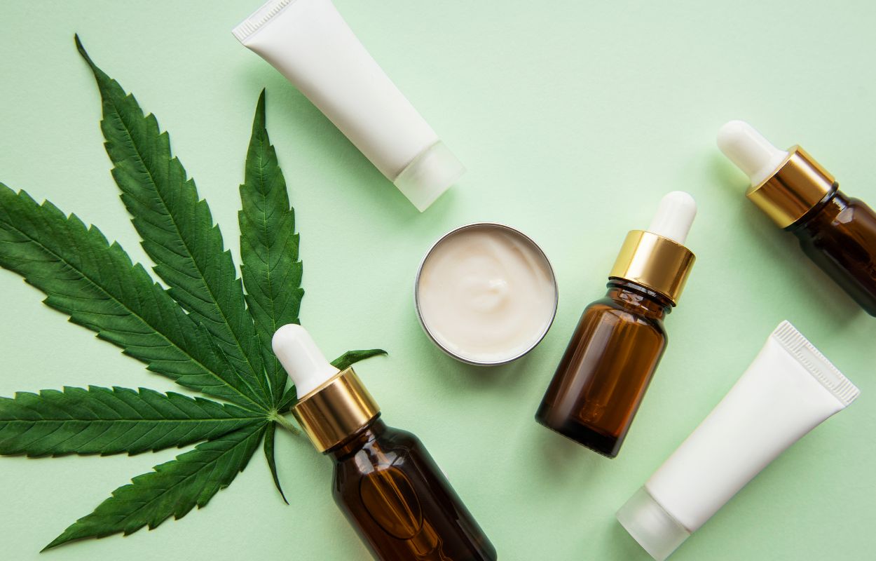 Topical products photographed with cannabis leaf.